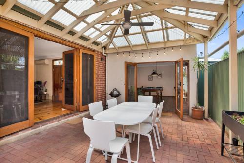 a conservatory with a table and chairs on a patio at City Edge Home From Home in Keswick