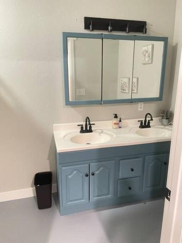 a bathroom with two sinks and a mirror at Desert Ranch Home 3 Bedroom + Equine Facility in Vail