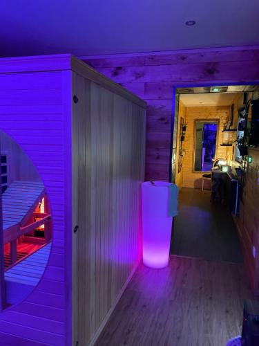 a room with a purple lighting in a house at Espace bien être Jacuzzi in Saint-Amand-les-Eaux