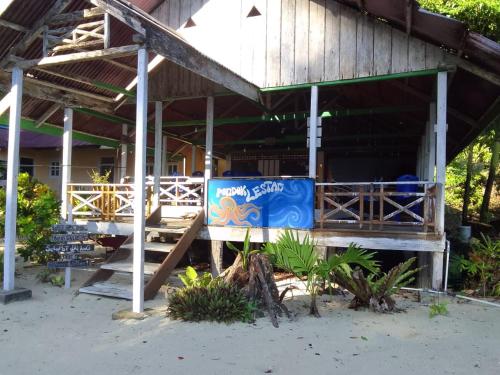a building with a sign on the side of it at Pondok Lestari Kadidiri in Batudaka