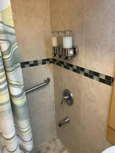 a shower in a bathroom with a glass door at Beach Front Condo in Isla Verde! in San Juan