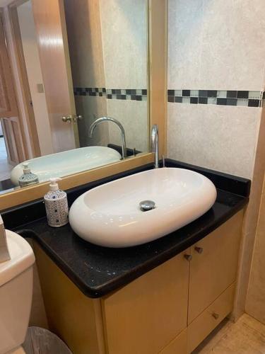 a bathroom with a white sink and a mirror at Beach Front Condo in Isla Verde! in San Juan