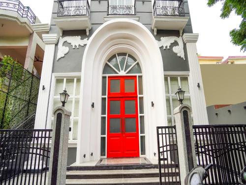 a red door on a house with stairs at Super Townhouse 380 Sector 19 Indiranagar Near Fun Republic Mall in Vibhuti Khand