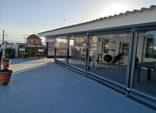 a patio with glass doors on a building at Domi's Rooftop Apartment in Thessaloniki