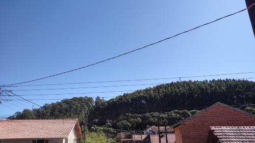 Blick auf einen Berg mit Bäumen und Häusern in der Unterkunft Apartamento Refúgio MV in Monte Verde