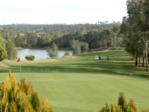 a view of a golf course with a lake at Clare Country Club in Clare