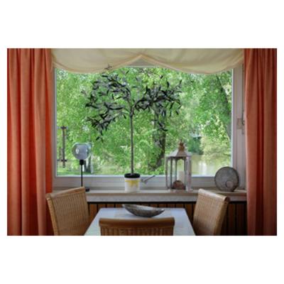 a dining room with a table and a large window at Haus am See in Horn-Bad Meinberg