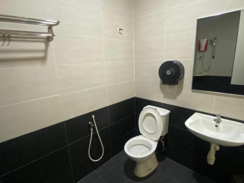 a bathroom with a toilet and a sink at D&F BOUTIQUE HOTEL SENAWANG in Senawang