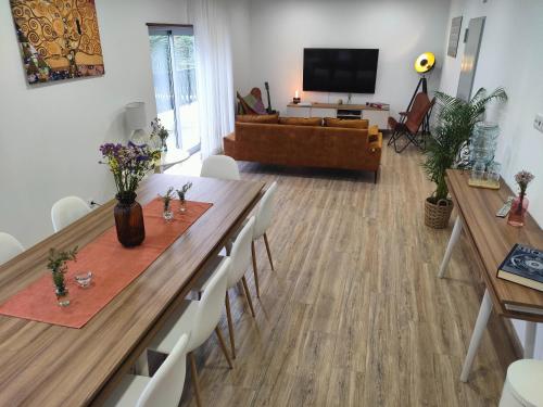 a living room with a long table and a couch at Embaixada da Vila in Cascais