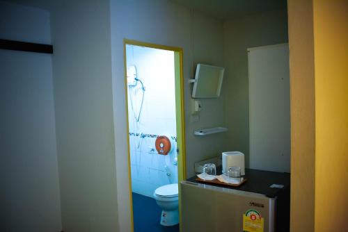 a bathroom with a shower and a toilet and a sink at Sabaidee Place in Phetchabun