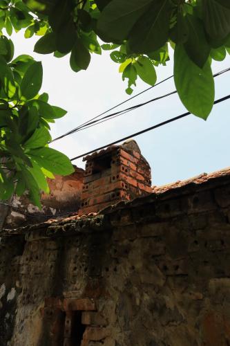 an old brick chimney on top of a building at Thom's House in Ninh Binh