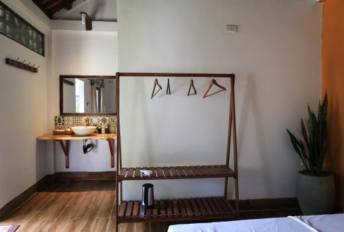 a room with a chair and a table and a mirror at Thom's House in Ninh Binh