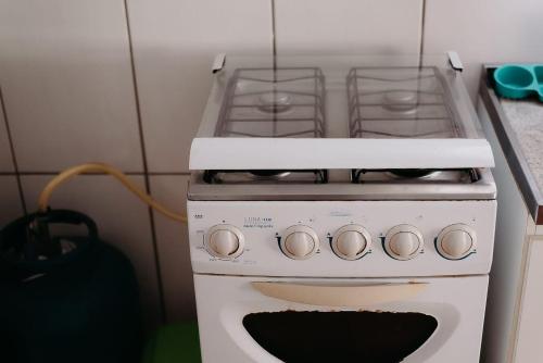 a white stove top oven in a kitchen at Ótimo custo benefício 2km centro wifi fogão lenha in Lages