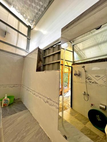 a bathroom with a shower and a glass door at Thang Hen Lake - Thang Hen Glamping & Eco Outdoor in Thăng Hen