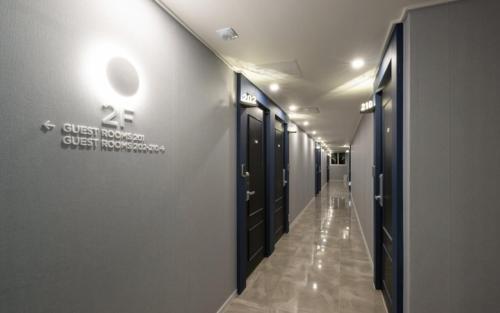 a hallway of a hospital with black lockers in a hallway at Hotel Yaja Gwangalli in Busan