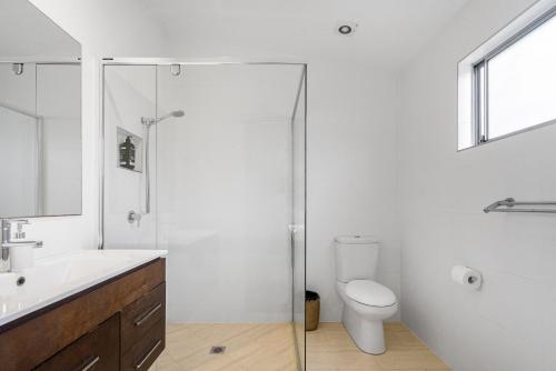 a bathroom with a toilet and a sink and a shower at Marie's Byron Getaway in Byron Bay