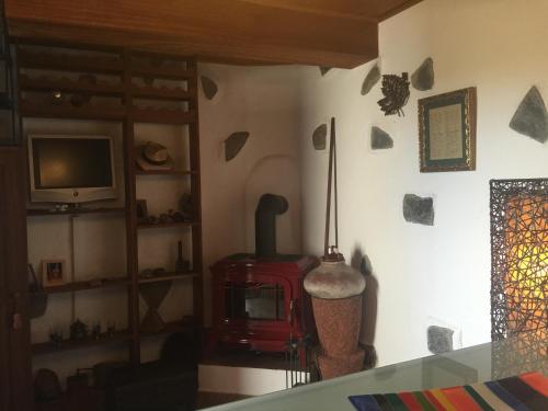 a living room with a wood stove and a tv at Casa rural Adoracion Chipude - Adults Only in Chipude