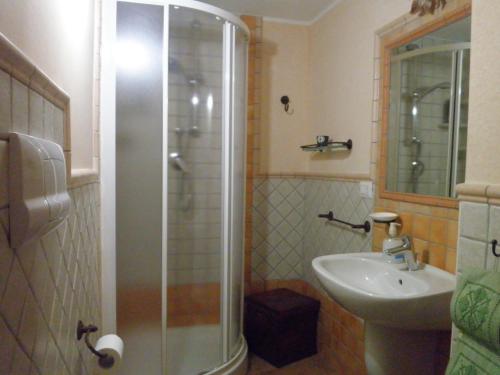 a bathroom with a shower and a sink at B&b Su Acu in Dorgali