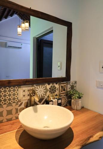 a bathroom with a bowl sink and a mirror at Thom's House in Ninh Binh