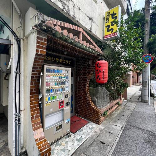 a vending machine on the side of a building at Tommy Condominium WAKASA301 in Kume