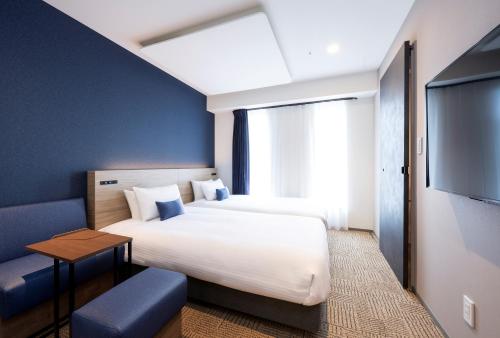 Ένα ή περισσότερα κρεβάτια σε δωμάτιο στο HOTEL AMANEK Shinjuku Kabukicho