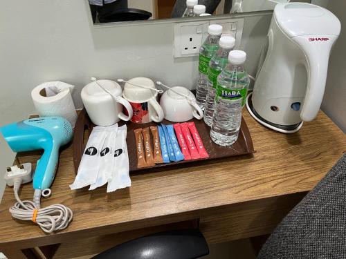 a desk with a coffee maker and water bottles on it at Prime Hotel at TRX Tower in Kuala Lumpur