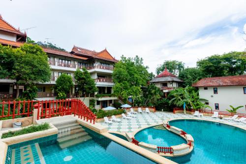 a pool at a resort with chairs and a swimming pool at Ao Nang Bay Resort in Ao Nang Beach