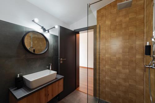 a bathroom with a sink and a mirror at Watra Chalet in Vatra Dornei