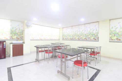 a room with tables and chairs and paintings on the walls at UNIQUE HOMESTAYS in Kondapur