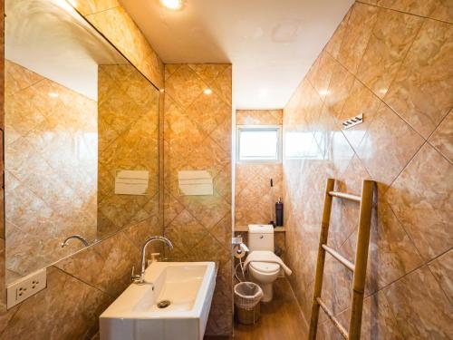 a bathroom with a sink and a toilet at Lemon House apartment in Mae Nam