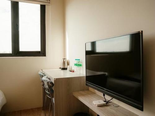 a large flat screen tv sitting in a room at 藍色星空庭園 in Jinning
