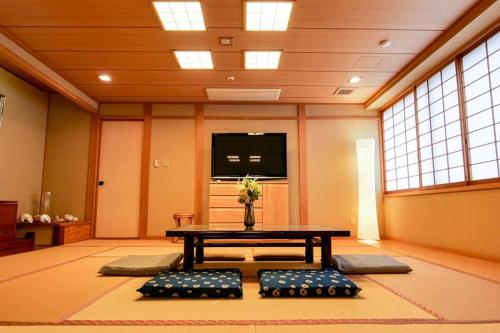 a room with a table with a vase on it at KODAKA Hotel TOKYO in Tokyo