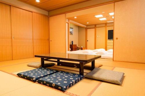 a coffee table in a room with a bed at KODAKA Hotel TOKYO in Tokyo