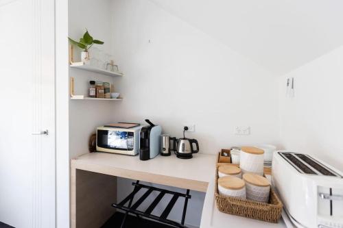 a kitchen with a counter top with a microwave at Scarborough Beach Break Holidays - Unit 3 in Scarborough