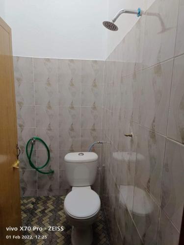 a bathroom with a toilet and a shower at ROO STAy TOK WAN 1 in Kampong Nail
