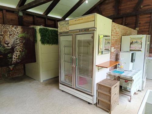 a large refrigerator in a room with a wall at Traveller Mountain Spring Farm in Beipu