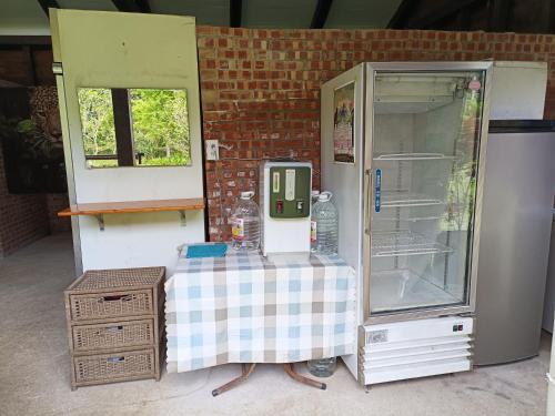 a small refrigerator with a table in a room at Traveller Mountain Spring Farm in Beipu