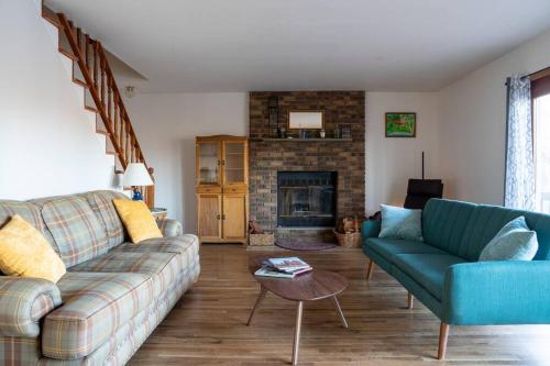 a living room with a couch and a fireplace at Lovely Liberty Chalet On the Waterfront in Liberty
