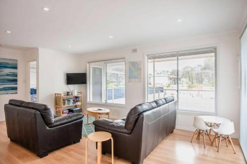 a living room with two leather chairs and a table at Almonta Escape - COFFIN BAY - Perfect for couples or families in Coffin Bay