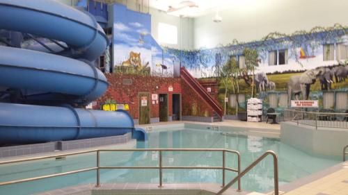 a large swimming pool with a water slide at Canad Inns Destination Centre Fort Garry in Winnipeg