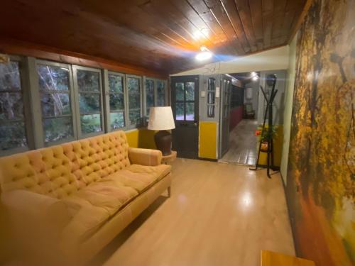 a living room with a couch and a lamp at The White House by Casona Lo Aguirre - El Monte RM in Talagante