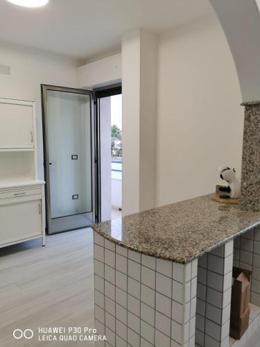 a kitchen with a counter top and a kitchen island at AriadiMare in Torre Ovo