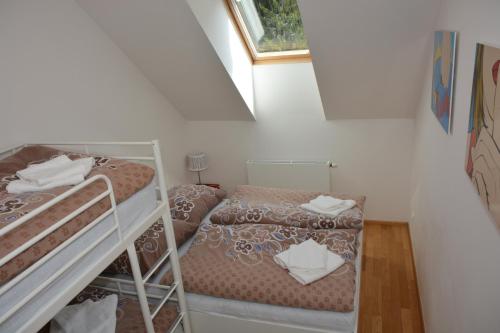 two bunk beds in a small room with a window at Apartmán Javor in Pec pod Sněžkou