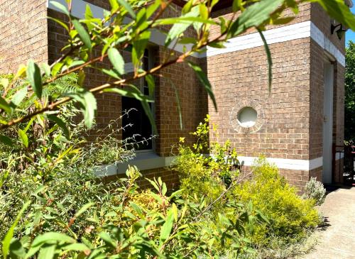 a brick building with a small window on it at Dora Hall - Very Central in Orange