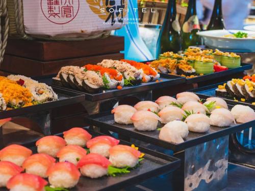 a display of different types of food on trays at Sofitel Zhengzhou International in Zhengzhou
