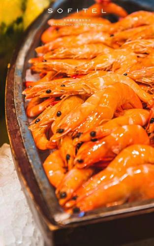 a pile of orange food on a table at Sofitel Zhengzhou International in Zhengzhou