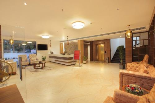 a large living room with couches and a couch at HOTEL MARIA PARK in Mūvattupula