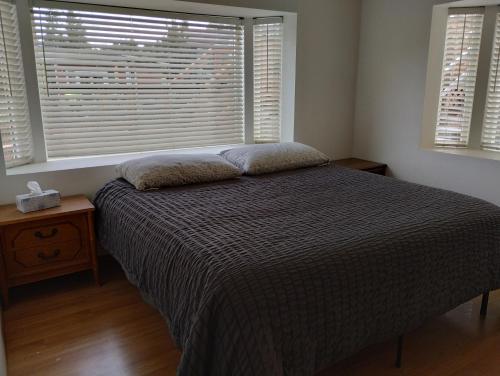 a bedroom with a bed and a large window at Waterfront Cabin - Homer Seaplane Base in Homer
