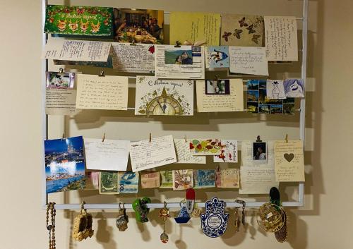 a wall with many papers and clocks on it at Neli & Zaal Guest House in Tʼelavi