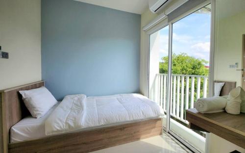 a bedroom with a bed and a large window at 98 Tower Chiang Mai in Chiang Mai